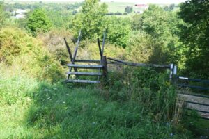 Stile next to closed gate in field south of Slader Creek Rd